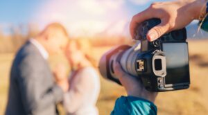 Someone taking a picture of a wedding couple